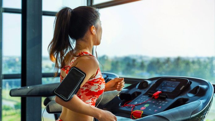 young woman running on a treadmill
