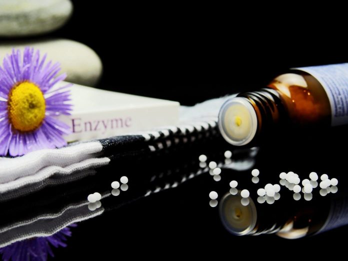 a bottle with softgels and word enzyme written