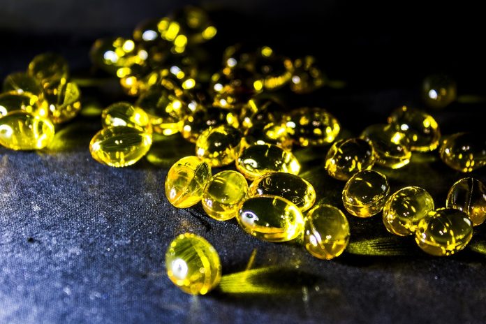 fish oil softgels on a blue background
