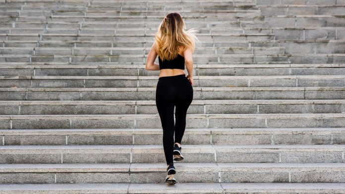 young woman running up on a staircase