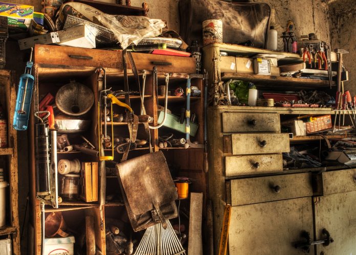 shelf in the garage with a lot of old junk stuff