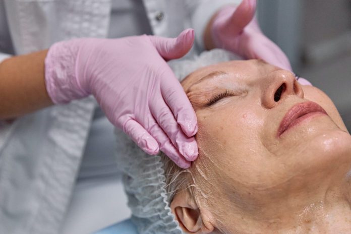 old lady getting a facial in a spa