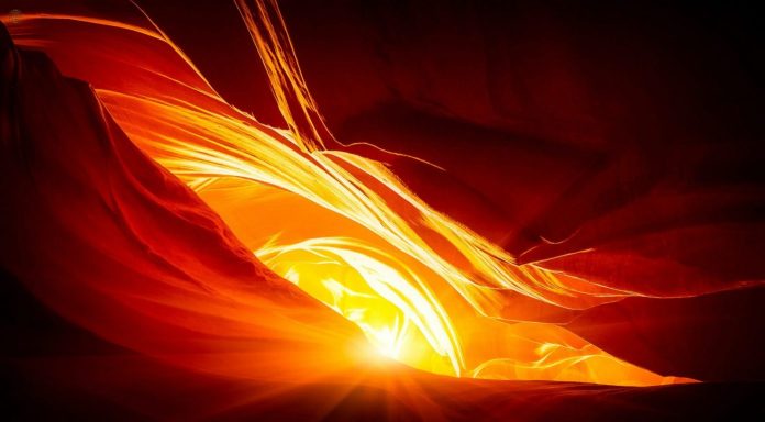 sunlight shining through a gap in a cave