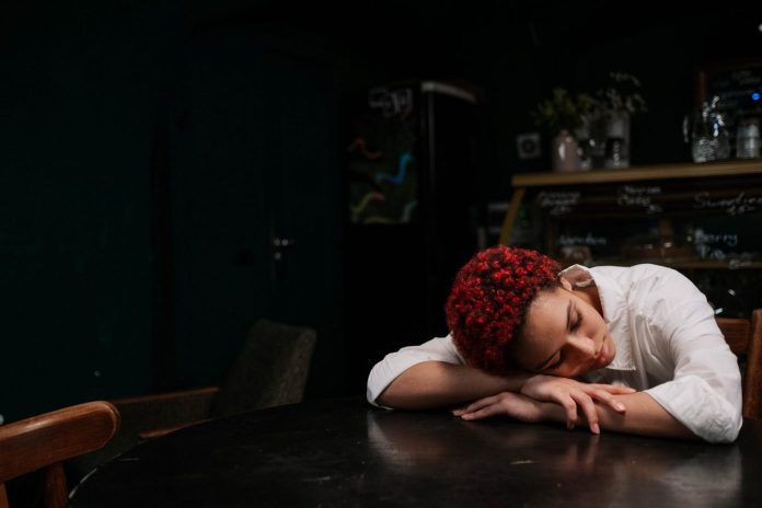 young lady sleeping on desk