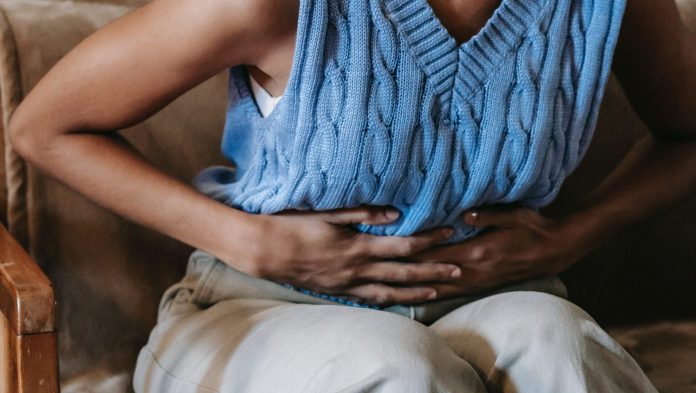 lady holding her stomach in pain