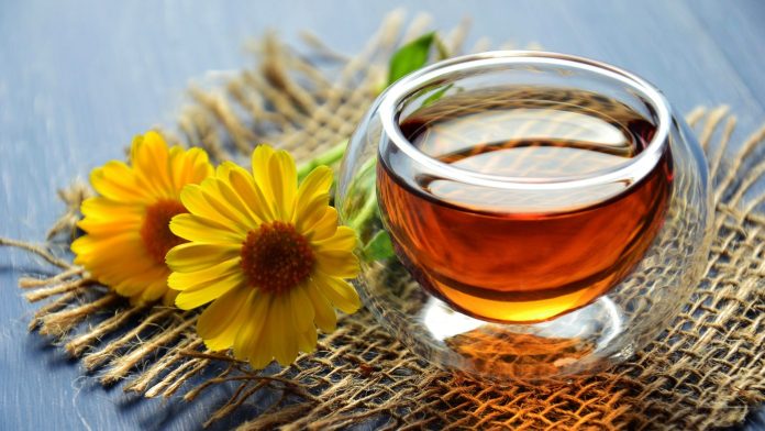 a cup of green tea on a mat