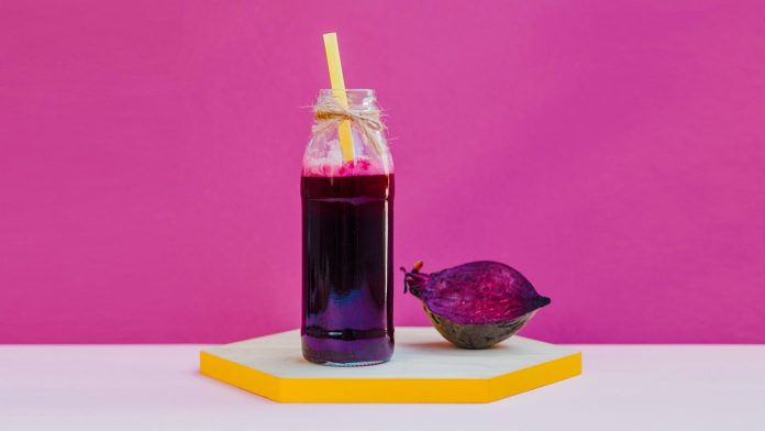 beetroot juice and beet on a wooden tray