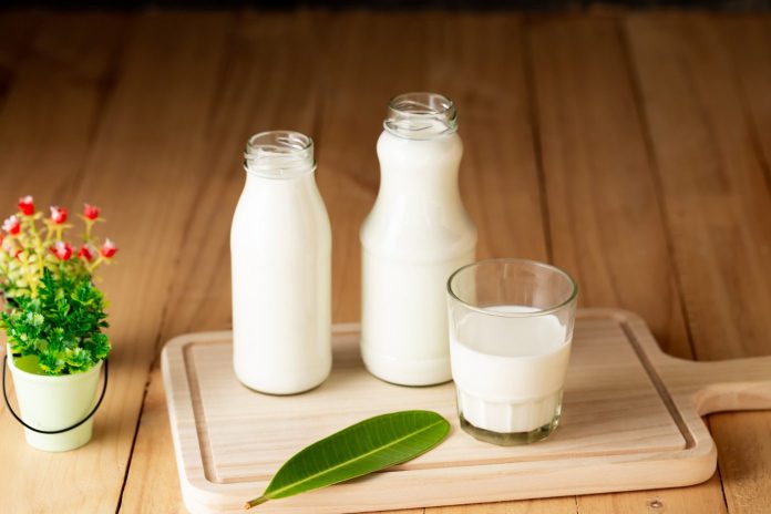 milk bottles and glass on table