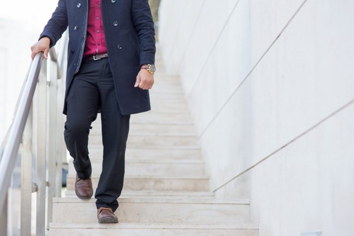 senior businessman walking down stairs