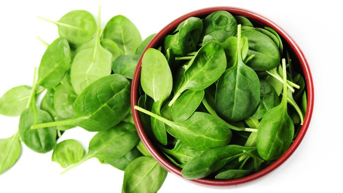 a bowl of fresh spinach leaves