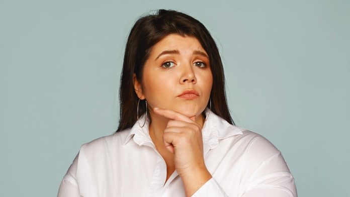 overweight young woman touching her chin