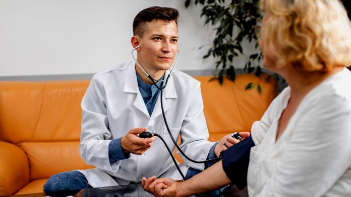 doctor measuring BP of a female patient