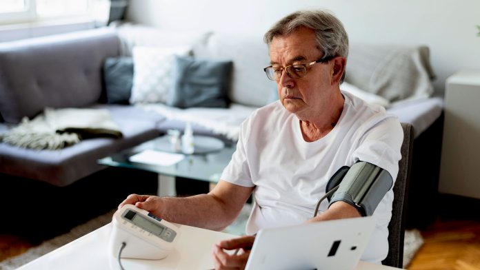 senior man monitoring own BP