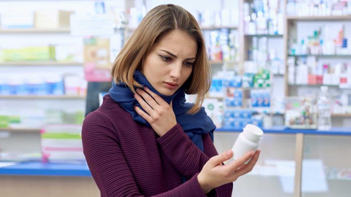 woman choosing pills in a drugstore