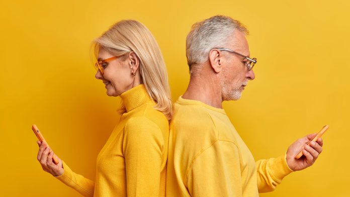 sideways-shot-old-woman-man-stands-back-each-other-yellow-studio