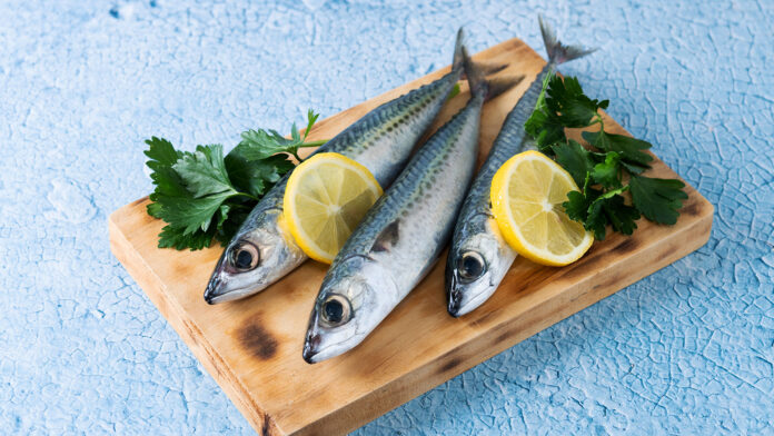 raw mackerel fish on a chopping board